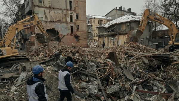 Ukrainian emergency service workers continue emergency and rescue operations at the site of a Russian missile strike in the central part of Kharkiv