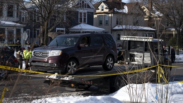 A vehicle is towed away after a shooting by an ICE agent during federal law enforcement operations