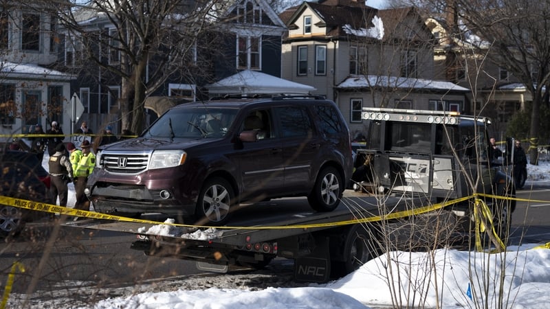 A vehicle is towed away after a shooting by an ICE agent during federal law enforcement operations