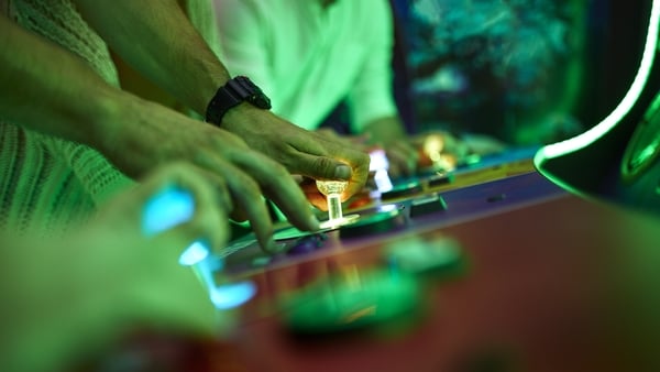 Close-up of friends playing in an amusement arcade