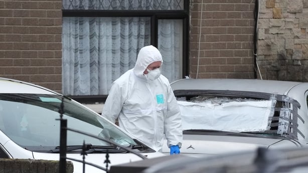 A member of An Garda Technical Bureau outside a property