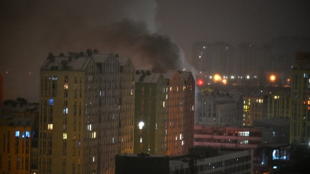 Smoke rises from a building after Russia launched an attack with drones and missiles on Kyiv 