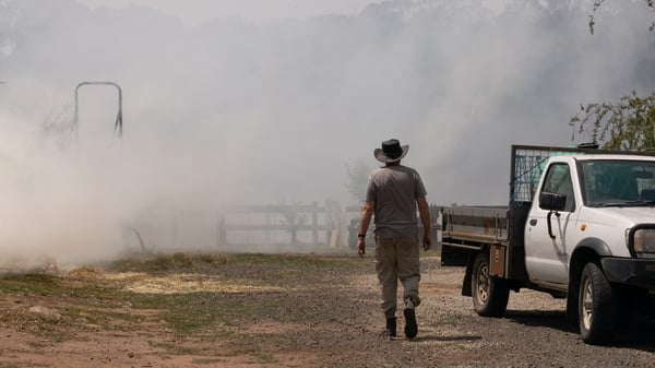A resident returns to find his property ablaze on January 10, 2026 near Longwood, Australia.