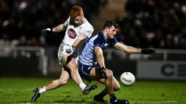 Harry O'Neill of Kildare scores his side's first goal despite the tackle of Cillian Dunne of Dublin during the Dioralyte O'Byrne Cup semi-final match between Kildare and Dublin at Cedral St Conleth's Park in Newbridge, Kildare. Photo by Ben McShane/Sportsfile