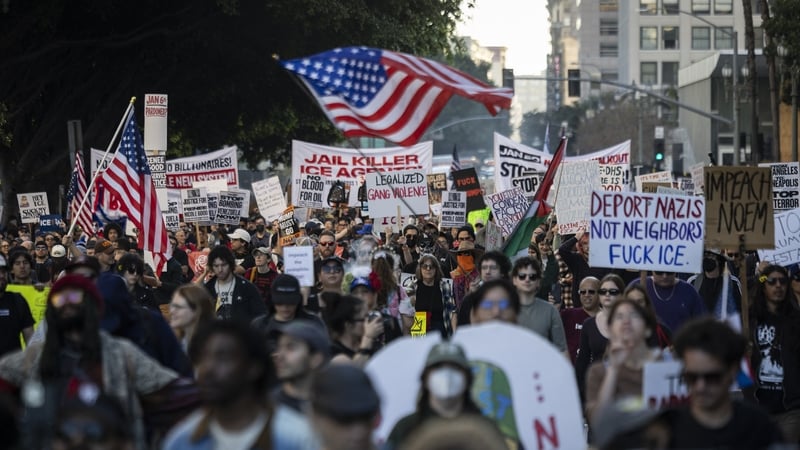 People wave flags and hold signs during a protest in Los Angeles, California on January 10, 2026 against US Immigration and Customs Enforcement (ICE
