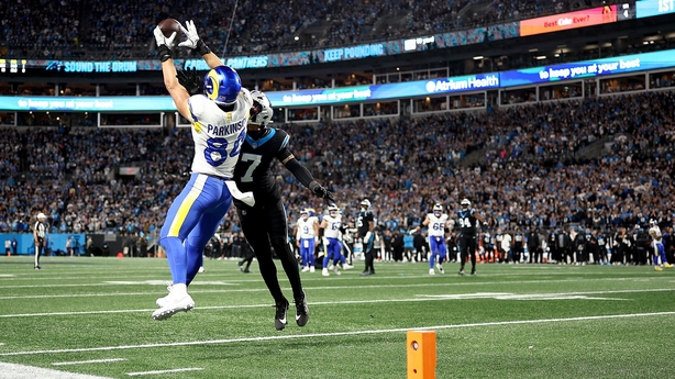 CHARLOTTE, NORTH CAROLINA - JANUARY 10: Colby Parkinson #84 of the Los Angeles Rams catches a 19 yard touchdown pass against Tre'von Moehrig #7 of the Carolina Panthers during the fourth quarter in the NFC Wild Card Playoff game at Bank of America Stadium on January 10, 2026 in Charlotte, North Caro