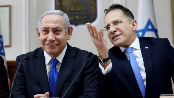 Israeli Prime Minister Benjamin Netanyahu (L) listens to Cabinet Secretary Tzachi Braverman at the start of the weekly cabinet meeting at his Jerusalem office