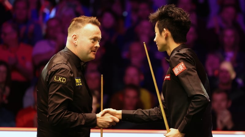 Shaun Murphy, left, shakes hands with Wu Yize after the first-round clash
