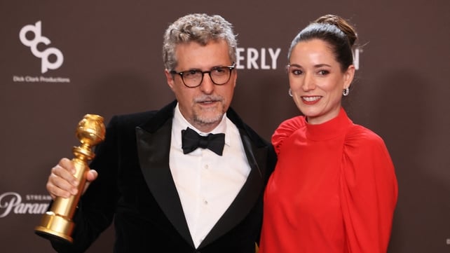 Brazilian director Kleber Mendonça Filho and French producer Emilie Lesclaux with the Golden Globe for Best Motion Picture, Foreign Language