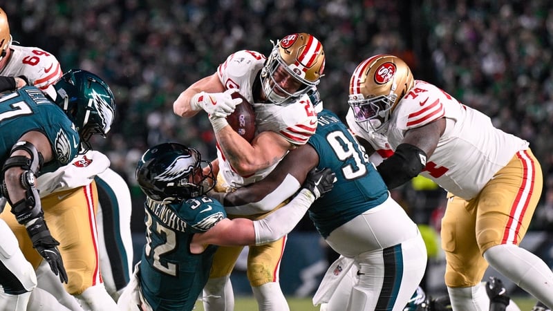 San Francisco 49ers running back Christian McCaffrey pushes through the Eagles defence