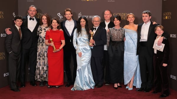 A group of people holding awards pose for a photograph