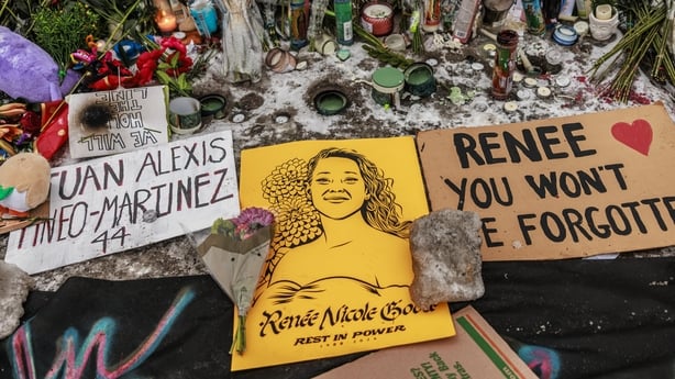 Candles, flowers and signs are placed at a makeshift memorial honouring Renee Nicole Good and other victims of police and immigration enforcement violence in Minneapolis