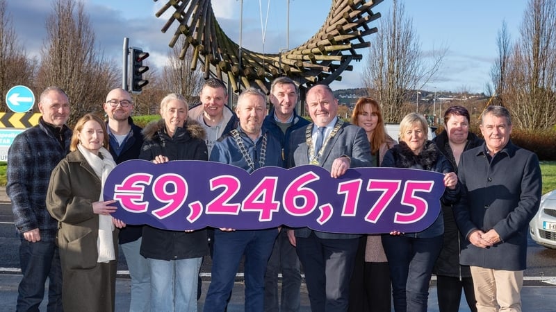 Letterkenny Chamber Executive celebrate the sale of €9,246,175.00 Shop LK Vouchers holding placard displaying the sales in euros