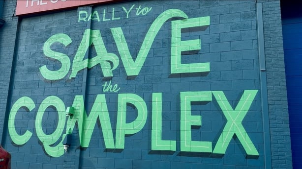 A mural reading 'rally to save The Complex' is painted on a wall in Dublin city centre