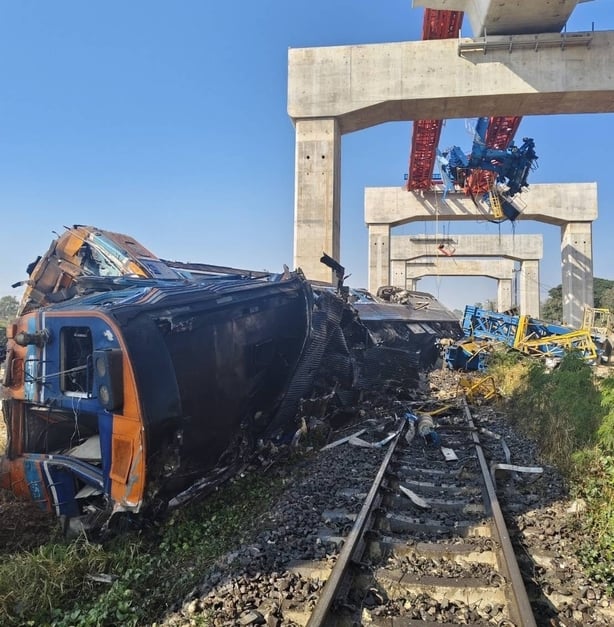 a derailed train lies on its side