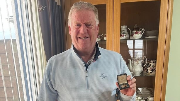 a photograph of peter murphy with an all ireland medal