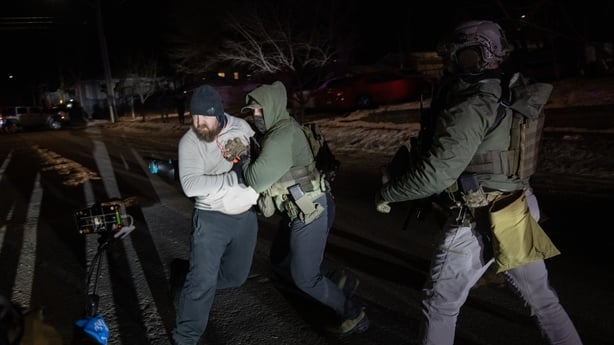 A man and law enforcement agents in a confrontation in Minneapolis
