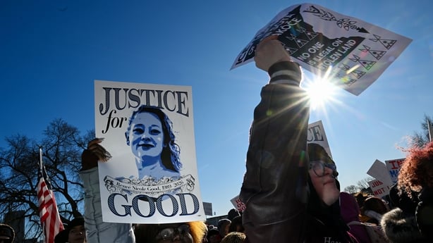 Protesters hold a picture of Renee Good in Minneapolis