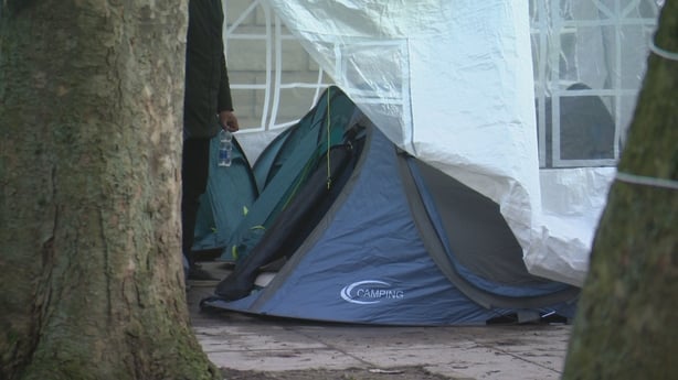 a blue tent seen inside a larger marquee tent