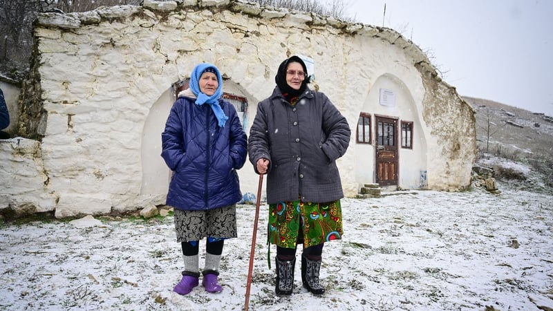 Maria Ardeleanu (L) stands next to her friend outside a 'basca' museum-house in Rogojeni