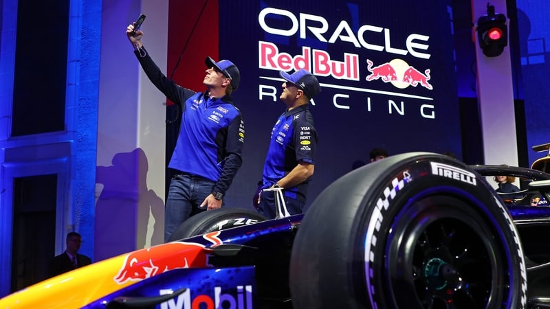 DETROIT, MICHIGAN - JANUARY 15: Isack Hadjar of France and Oracle Red Bull Racing and Max Verstappen of the Netherlands and Oracle Red Bull Racing take a selfie with their car on stage during the Red Bull Racing season launch at Michigan Central Station o