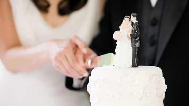 close up of a bride and groom cutting their wedding cake