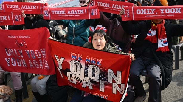 Supporters of South Korea's impeached former president Yoon Suk Yeol with scarves and banners