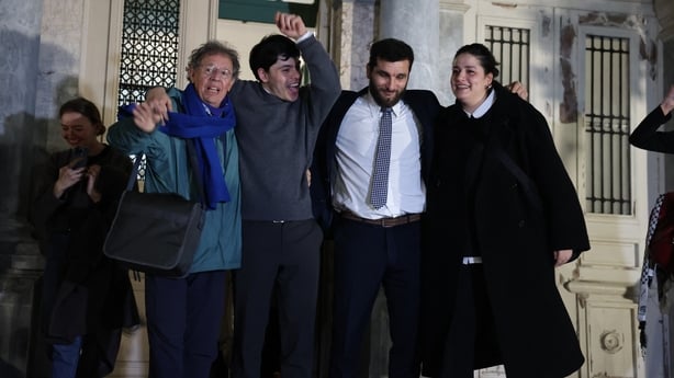Sean Binder (second left) with Sarah Mardini (right), Nasos Karakitsos (second right) and Pieter Wittenberg react as they exit the courthouse in Mytilene yesterday
