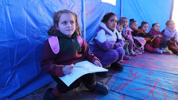 BEIT LAHIA, GAZA - DECEMBER 23: A group of volunteer teachers set up educational tents for students deprived of schooling due to the blockade in the area in Beit Lahia, Gaza on December 23, 2025. The teachers provide instruction in core subjects, primaril