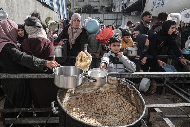 GAZA CITY, GAZA - JANUARY 12: Palestinians gather to receive hot meal, distributed by charity organizations, as the food crisis continues due to limited humanitarian aid in Nuseirat Refugee Camp, located in the central Gaza Strip on January 12, 2026. A large number of Palestinians, including childre
