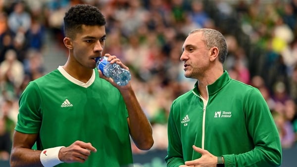 Michael Agwi of Ireland, left, with Team Ireland captain Conor Niland during his singles match on day one of the Davis Cup World Group I Play-off 1st Round match between Ireland and Austria at UL Sport Arena in Limerick.