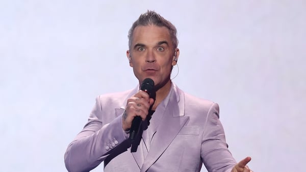 WASHINGTON, DC - DECEMBER 05: Robbie Williams performs during the FIFA World Cup 2026 Official Draw at John F. Kennedy Center for the Performing Arts on December 05, 2025 in Washington, DC. (Photo by Hector Vivas - FIFA/FIFA via Getty Images)