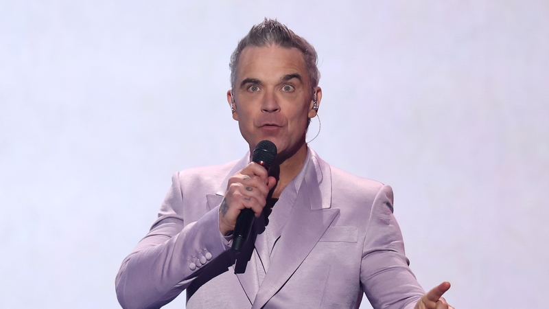 WASHINGTON, DC - DECEMBER 05: Robbie Williams performs during the FIFA World Cup 2026 Official Draw at John F. Kennedy Center for the Performing Arts on December 05, 2025 in Washington, DC. (Photo by Hector Vivas - FIFA/FIFA via Getty Images)