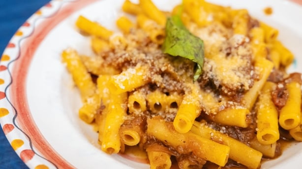A plate of traditional Pasta alla Genovese, a rich and flavorful pasta dish from Naples, featuring slow-cooked onions and meat.