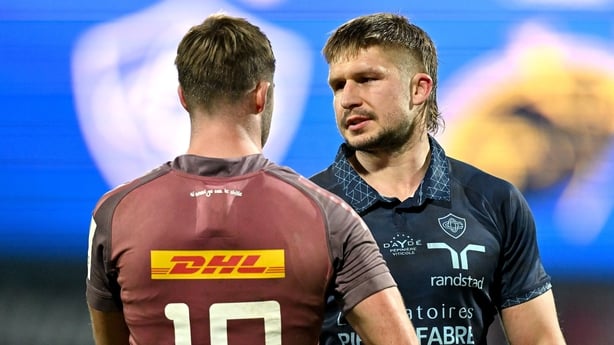 13 December 2024; Jack Goodhue of Castres Olympique, right, and Jack Crowley of Munster after the Champions Cup Pool 3 match between Castres Olympique and Munster at Stade Pierre Fabre in Castres, France. Photo by Brendan Moran/Sportsfile