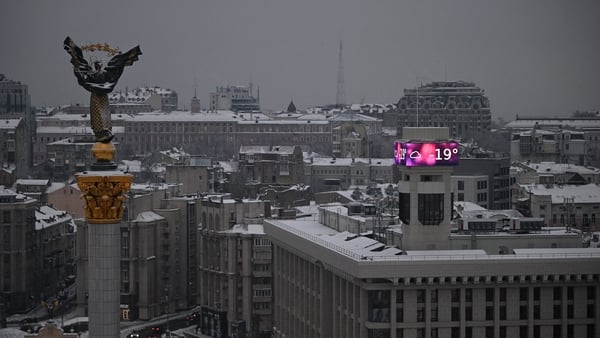 Cars drive along the Independence Square as a big screen on a building displays a temperature of -19 degrees Celsius in Kyiv on January 15, 2026, amid the Russian invasion of Ukraine. Ukraine's President Volodymyr Zelensky said on January 14 a 'state of e