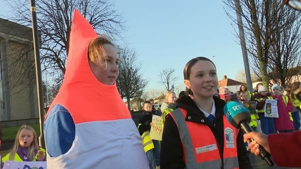 Two school children interviews on news2day at a road safety event. One on the left dressed as a traffic cone.