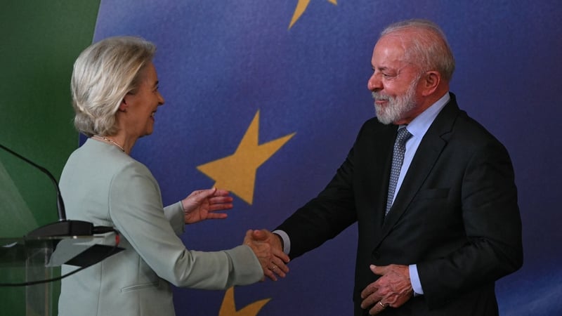 President of the European Commission Ursula von der Leyen and Brazil's President Luiz Inacio Lula da Silva shake hands as they meet ahead of the deal signing