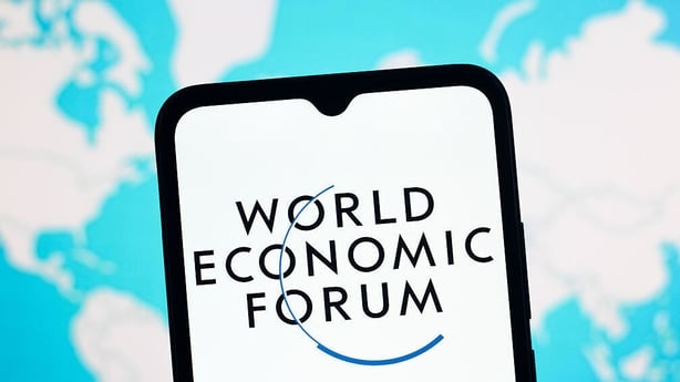 The World Economic Forum logo is seen displayed on a smartphone screen