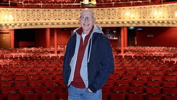 Actor Joe Conlan stands on stage at the Gaiety Theatre