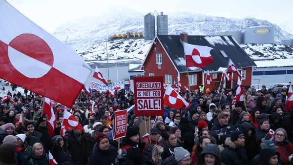NUUK, GREENLAND - JANUARY 17: People hold Greenlandic flags and placards as they gather by the United States Consulate to march in protest against U.S. President Donald Trump and his announced intent to acquire Greenland on January 17, 2026 in Nuuk, Green