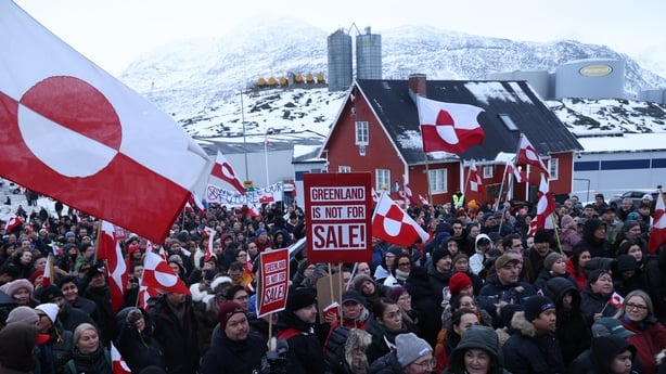 NUUK, GREENLAND - JANUARY 17: People hold Greenlandic flags and placards as they gather by the United States Consulate to march in protest against U.S. President Donald Trump and his announced intent to acquire Greenland on January 17, 2026 in Nuuk, Greenland. Greenlandic, Danish and other European 