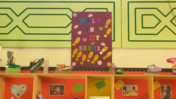 A poster with text saying Walk in my Shoes