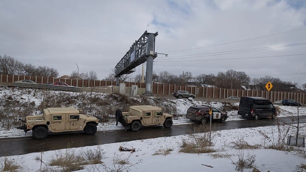 Minnesota Army National Guard soldiers post up along a freeway ramp ahead of anticipated protests yesterday