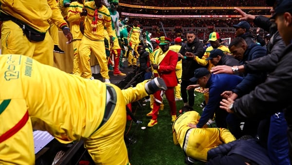 Security personnel block angry fans over a penalty decision against Senegal during the Africa Cup of Nations (CAN) final football match between Senegal and Morocco at the Prince Moulay Abdellah Stadium in Rabat on January 18, 2026.