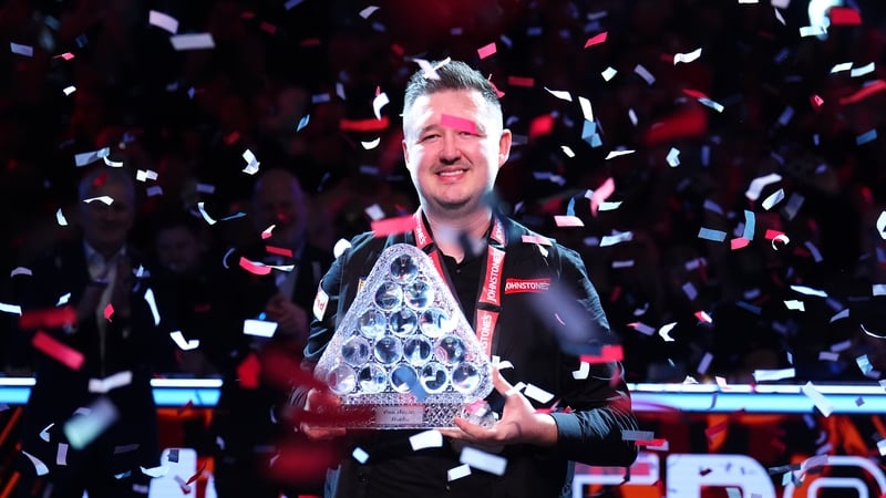 Kyren Wilson poses with the the Paul Hunter Trophy at Alexandra Palace