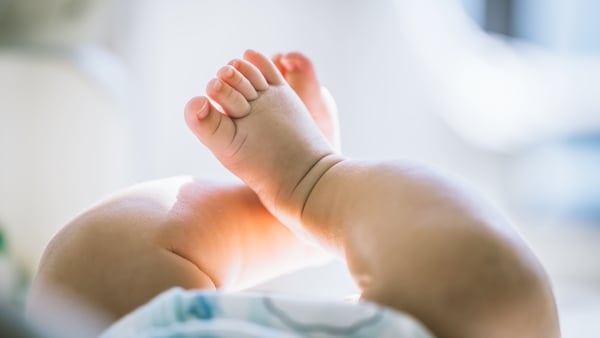 Close up of a four months old baby's legs and feet