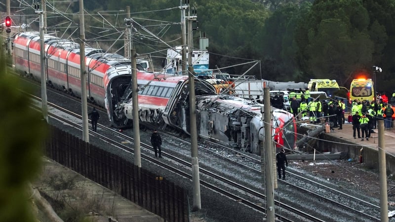 Members of the Spanish Civil Guard, along with other emergency personnel, work next to one of the trains involved