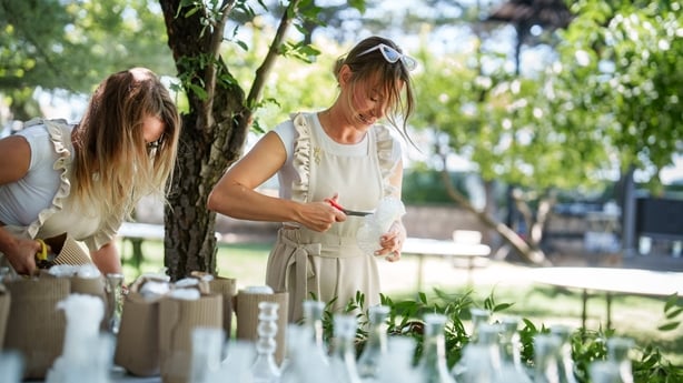 Moments of the team working on floral decorations for a wedding event.