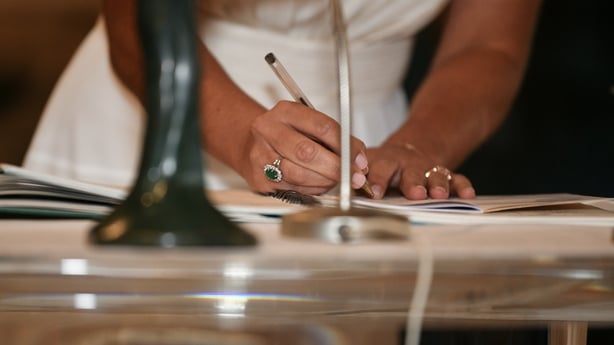 A bride signs the marriage registration documents